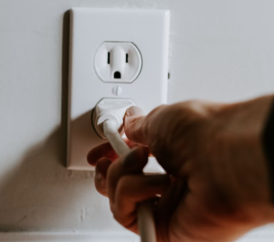 hand on electrical outlet