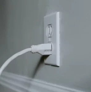 White chord plugged into outlet