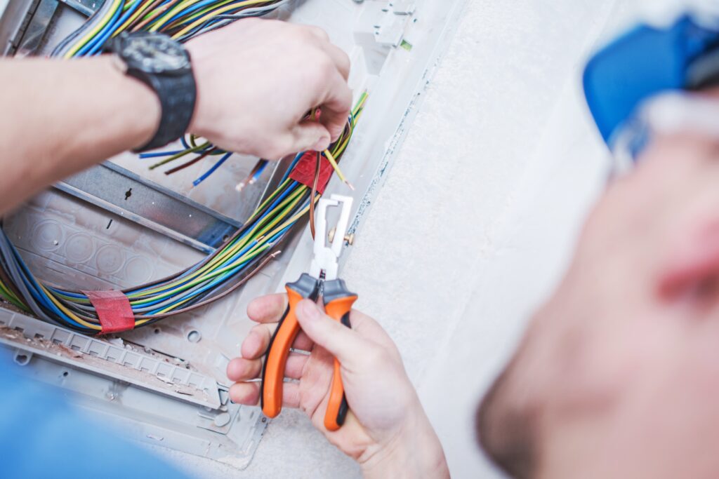 Caucasian Electrician and His Job. Electric Technician Preparing Cables.