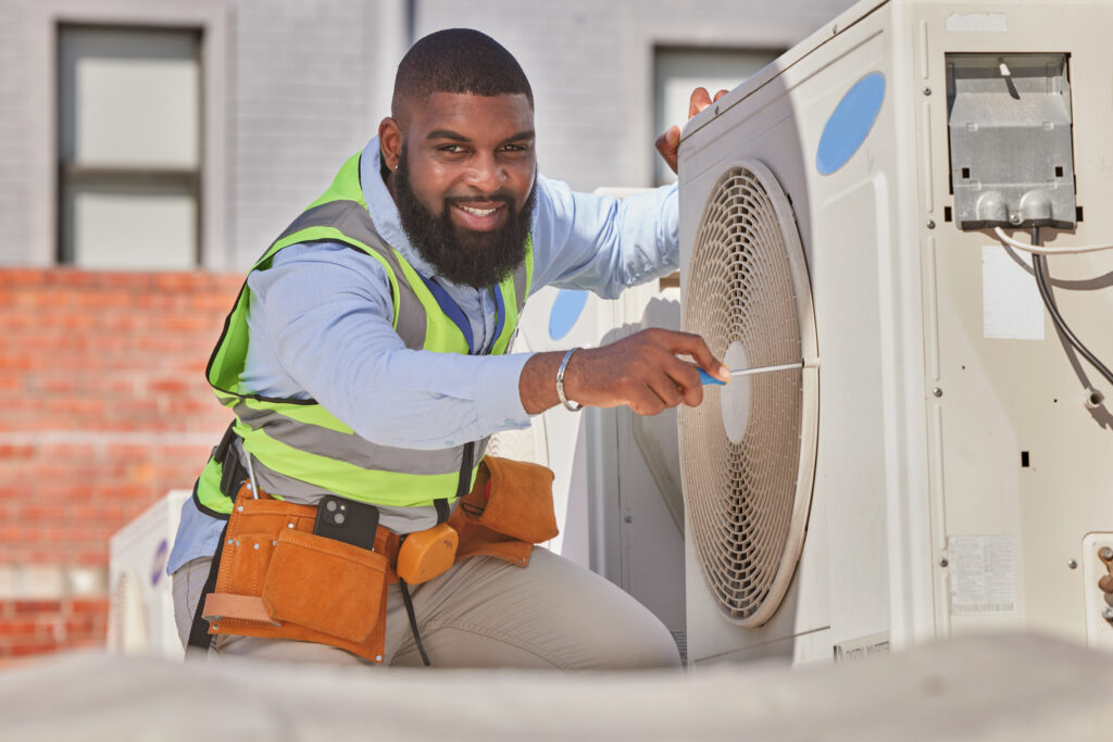 Black man, portrait and maintenance, AC repair and engineering with smile and labor outdoor. Africa.