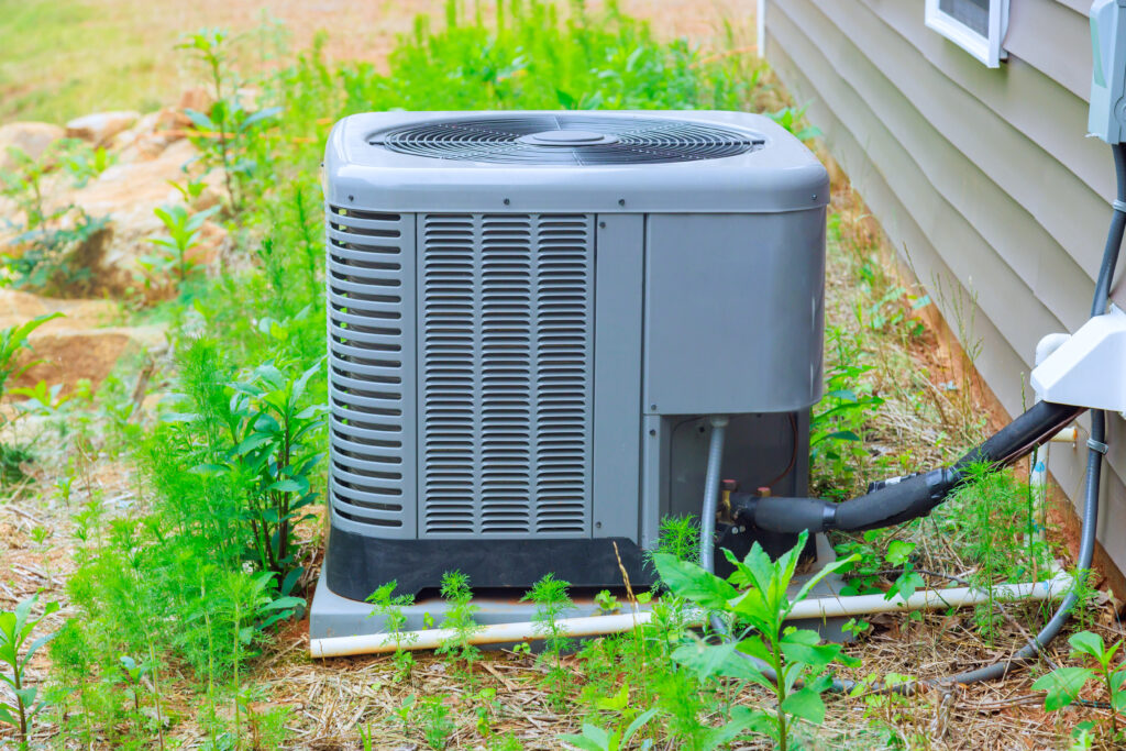 Installed on exterior facade of house is an outdoor air conditioning system unit